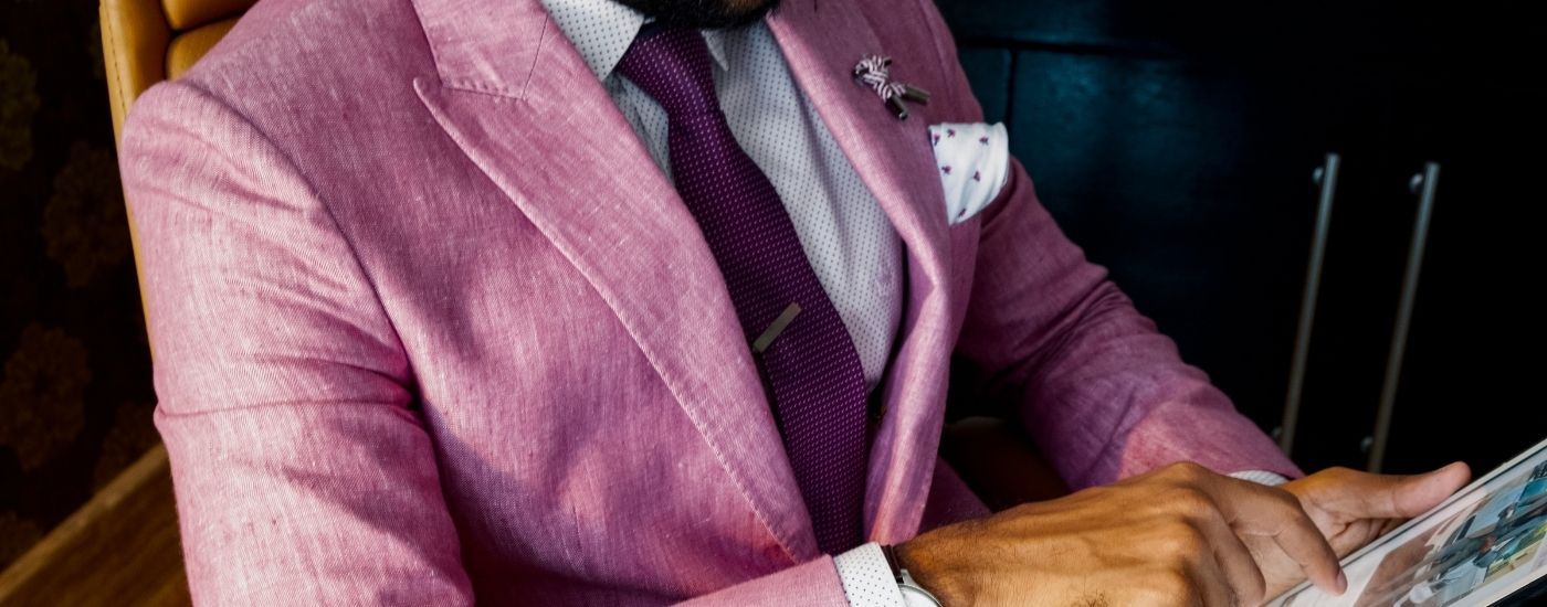 Gentleman in a stylish pink suit with a tie and cufflinks 